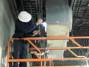 A perfectemp technician brazes an evaporator unit