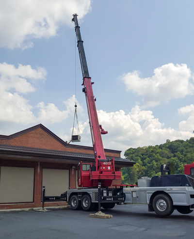 One view of our installation crew using a crane to install equipment
